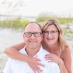 mom hugging dad on beach