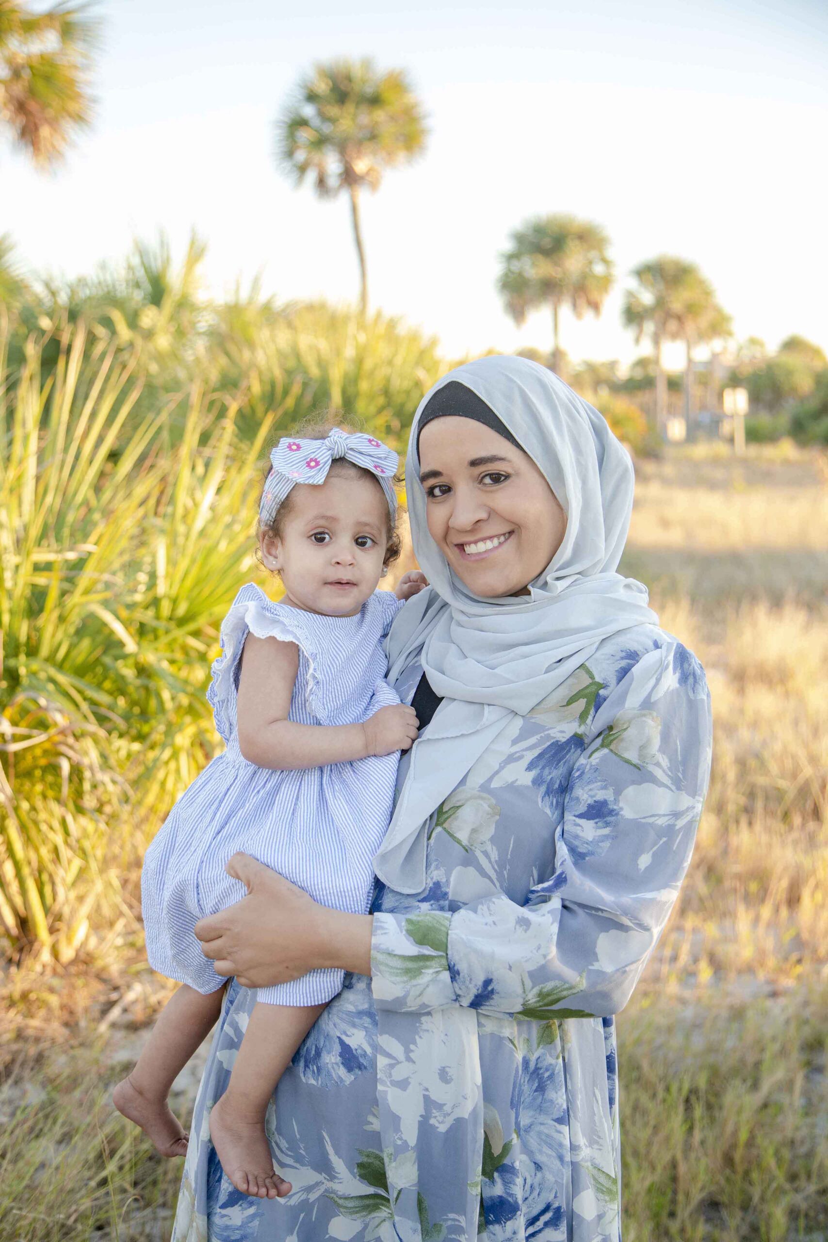 mom holding daughter on the beach- tampa florida photographer