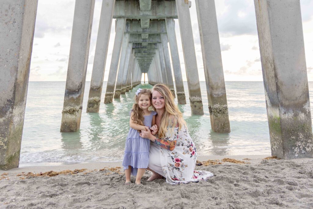 mom and daughter under venice pier