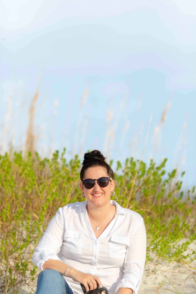 photographer sitting on beach with camera- tampa florida photographer