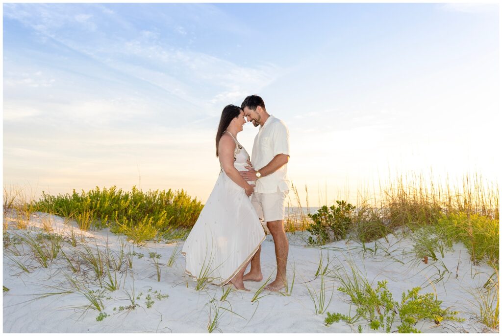 expecting couple embrace for maternity portraits