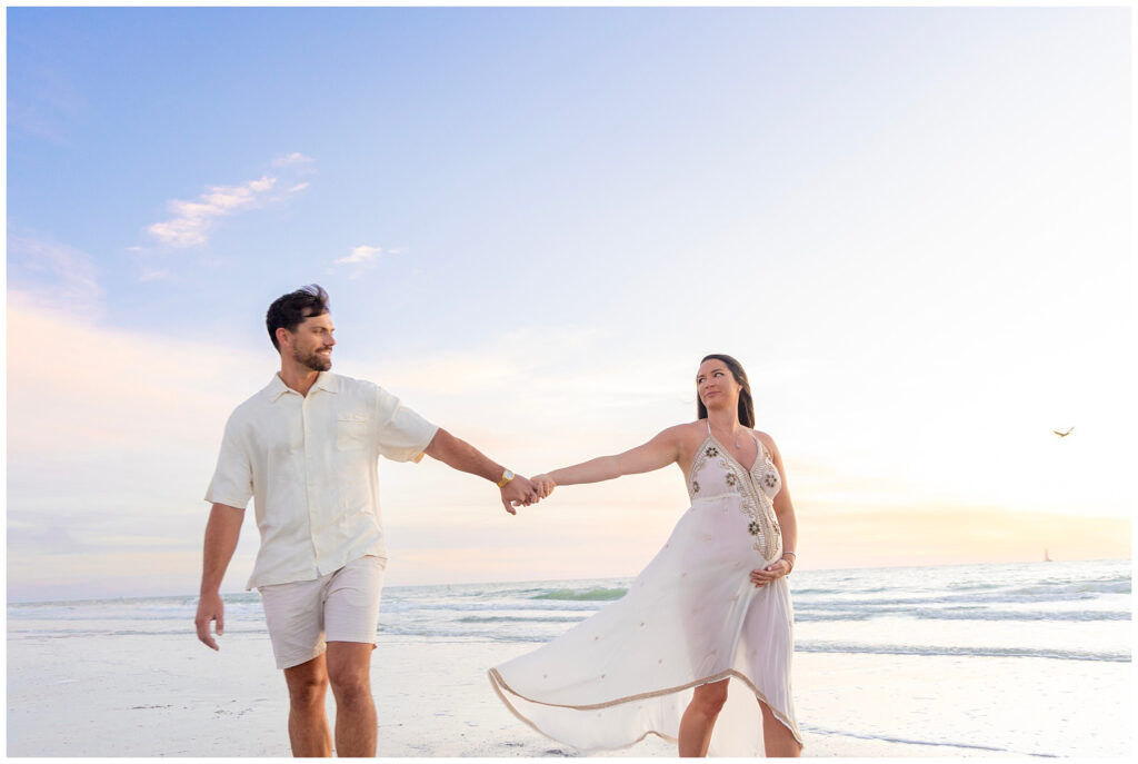 couple holding hands expecting a baby maternity photos